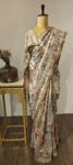 NrityaVilaas – Iktara’s Regal Rhythm in Threads

A regal creation from the Iktara line, this saree blends soft elegance with detailed hand embroidery depicting dancing beauties and floral artistry on a classic base.
