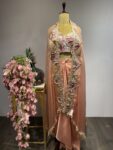 Tassel Tale: Peach Drape Skirt Set with Luxe Embroidered Cape