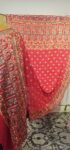 Red bandhani dupatta in maharaj maharani concept. (Odhana)