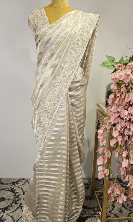 Silver organza saree with hand done border.