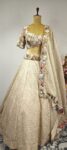 Multi colour embroidered blouse with beige crushed tissue lehenga