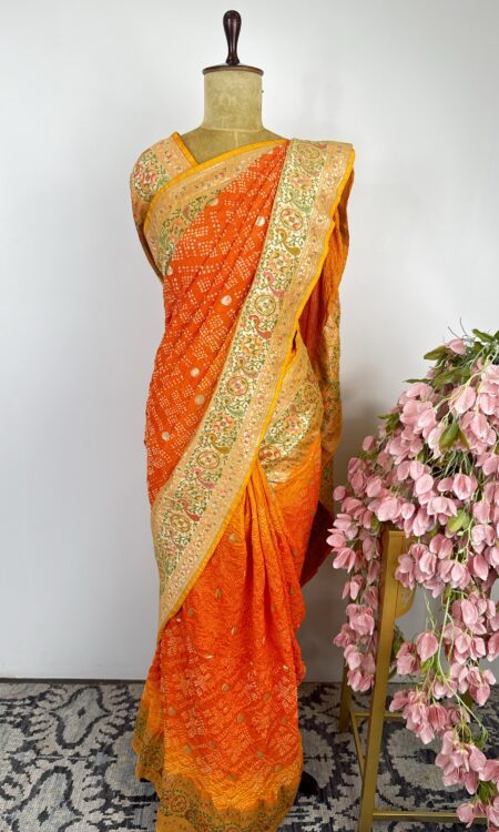 Yellow to orange bandhani saree